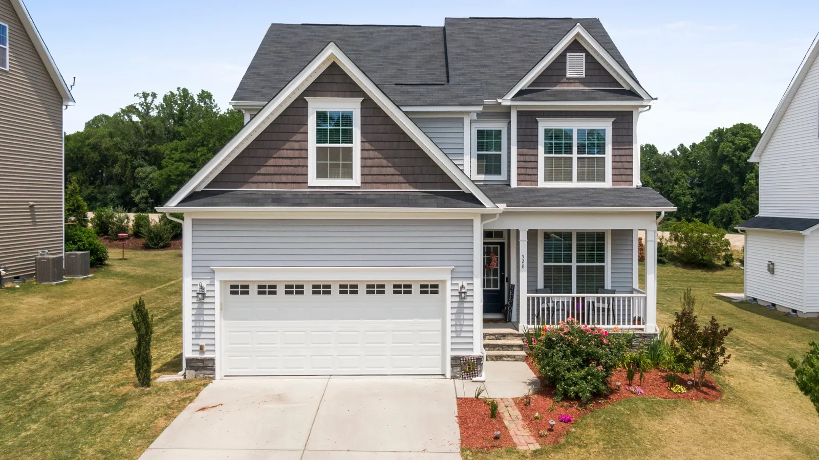 Dark shingle roof over a two-story home with covered front porch